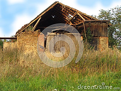 Abadoned barn ruin on the edge of the village Stock Photo