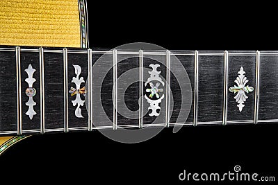 Abalone and Mother of Pearl Hand Cut Inlays on an Acoustic Guitar Stock Photo
