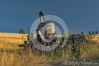 Abandon Combine in a wheat field Stock Photo