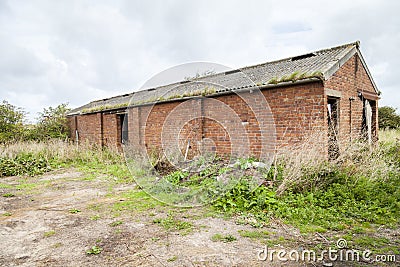Abandoned agricultural red brick outbuilding Stock Photo