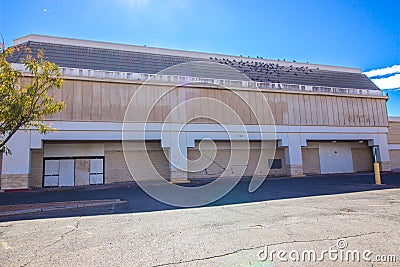 Abandoned Big Box Commercial Store With Boarded Up Entrance Stock Photo