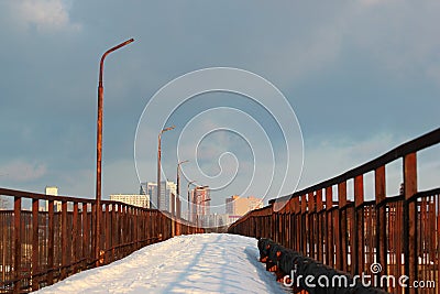 Abandoned bridge at a railway station, covered with snow at wintertime Stock Photo