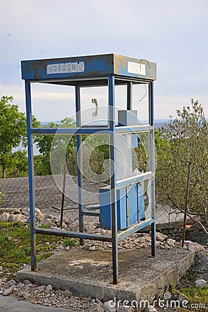 Abandoned and broken public telephone booth Stock Photo