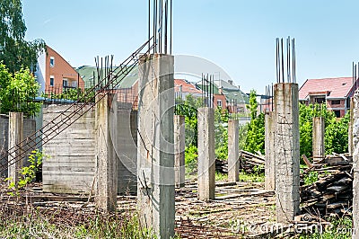 Abandoned building or house unfinished construction site with architectural details of concrete skeleton and reinforcement poles a Stock Photo