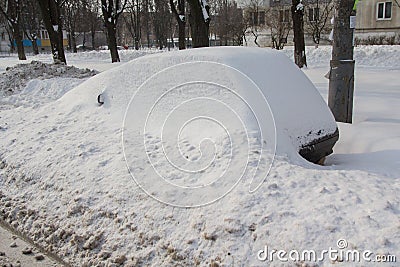 Abandoned car brought by snow on a roadside Stock Photo