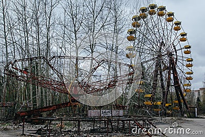 Abandoned carousel and abandoned ferris at an amusement park in the center of the city of Pripyat, the Chernobyl disaster, Editorial Stock Photo