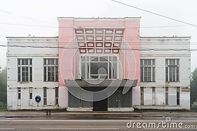 Abandoned cinema in Orel, Russia in morning haze with empty chair in front Stock Photo