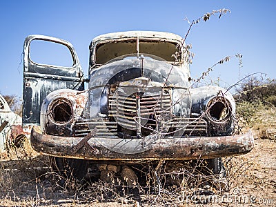 Abandoned classic car rusting in Namib desert, Namibia Stock Photo