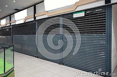 Abandoned closed shutter shop in department store Stock Photo