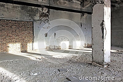 Abandoned concrete hall lit by sunlight Stock Photo