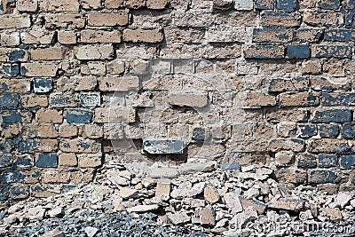 Abandoned cracked and destroyed gray brick wall closeup Stock Photo