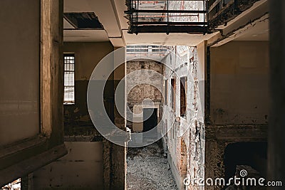 Abandoned, damaged interior building with falling apart brick walls and debris Stock Photo