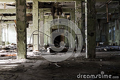 Abandoned and dangerous production premise with trash on floor. Stock Photo