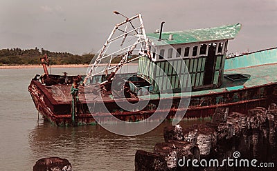 Abandoned fisherman boat on a indian small harbor. Stock Photo