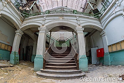 Abandoned girls high school, lycee V in Belgium. Fish-eye shot on the beautiful staircase. Editorial Stock Photo
