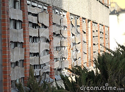 Abandoned grunge cracked brick wall with boarded up windows Stock Photo