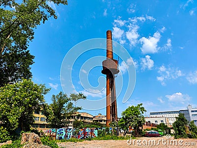 Abandoned historical tall industrial smokestack in the renovated business zone Pragovka during beautiful weather Editorial Stock Photo
