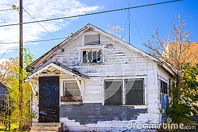 Abandoned Home In Disrepair With Barred Windows Stock Photo