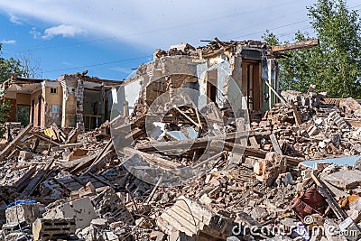 An abandoned house collapses. The house is destroyed. Cracks in wall of house. Destruction of old houses Stock Photo