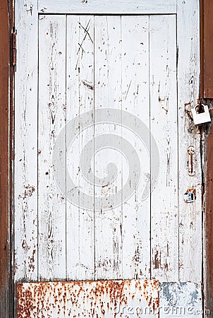Abandoned house door texture background. Locked wooden entrance with old fashion padlock. Blue, white and brown peeled off paint Stock Photo