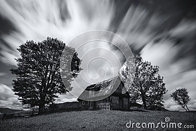 Abandoned house in West Ukraine.Old spooky abandoned farm house in black-white color. An old, long-abandoned house,against the bac Stock Photo