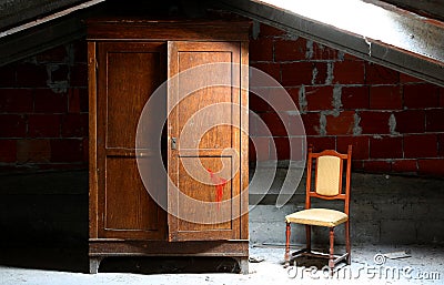 abandoned house with wooden closet and a chair Stock Photo