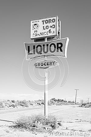 Abandoned liquor and grocery sign in Mortmar, on the Salton Sea in California Editorial Stock Photo