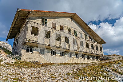 Abandoned Military Barracks on the mountain side in the clouds Stock Photo