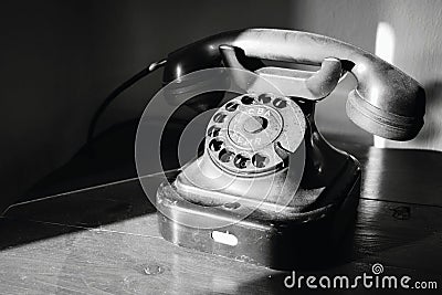 Abandoned nostalgic dial telephone in black and white Stock Photo