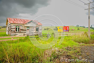 Abandoned old farm house with MacDonald s and gym signs on roadside Editorial Stock Photo