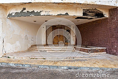 Abandoned old grunge wooden double leaves door and brown stone bricks wall Stock Photo