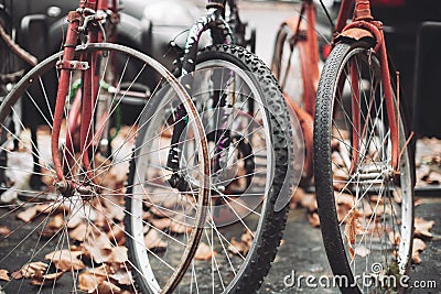 Abandoned old rusty bicycles on city streets Stock Photo