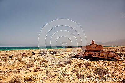 Abandoned old rusty tank on the shore of the island. Stock Photo