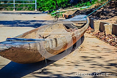 Abandoned old wooden boat on the shore. Shipwrecked wooden fishing boat on the land. Stock Photo