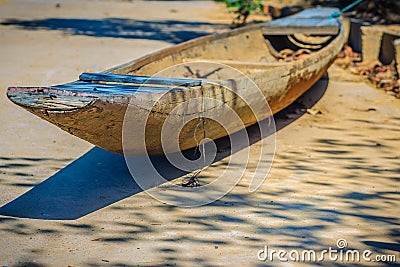 Abandoned old wooden boat on the shore. Shipwrecked wooden fishing boat on the land. Stock Photo