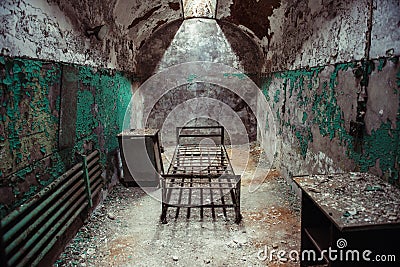 Abandoned prison cell walkway with old rusty stairs, doors and peeling walls. Stock Photo