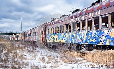 Abandoned railroad cars under threatening winter sky. Albany County, NY. Editorial Stock Photo