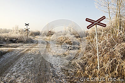 Abandoned railway track in freezing weather, rail crossing, sunny freezing weather, little dusting of snow Stock Photo