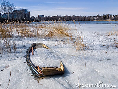 Abandoned rowing boat full of ice and snow Stock Photo