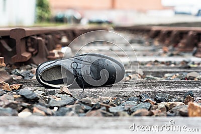 Abandoned shoe on train tracks Stock Photo