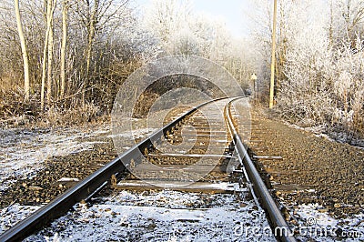 Abandoned single track railway line in sunny freezing weather Stock Photo