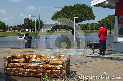 Abandoned Sofa and Flooded Neighborhood Stock Photo