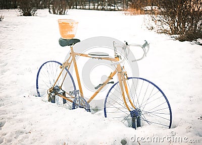 An abandoned sport cycle in the snow Stock Photo