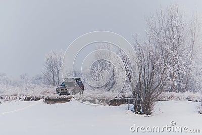 An abandoned SUV on a hill in the snow. Stock Photo