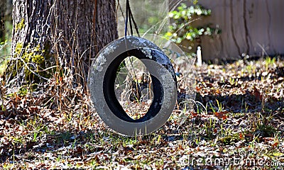 Abandoned Tire Swing Beside Home Stock Photo