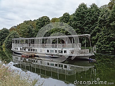 Abandoned tourist boat on a side arm of river Meuse Editorial Stock Photo