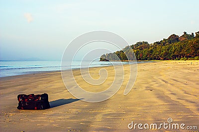 Travel bag on the beach Stock Photo