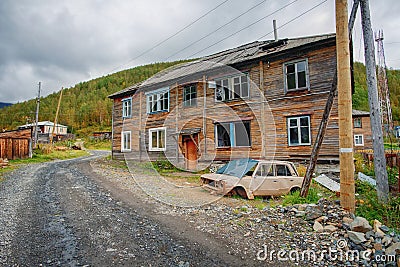 Abandoned village with crumbling empty buildings and abandoned cars in Khakassia Stock Photo