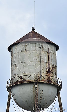 Abandoned water tower has rusty roof Stock Photo