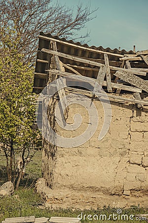 Abanoned old traditional house in ukranian village with damaged roof Stock Photo